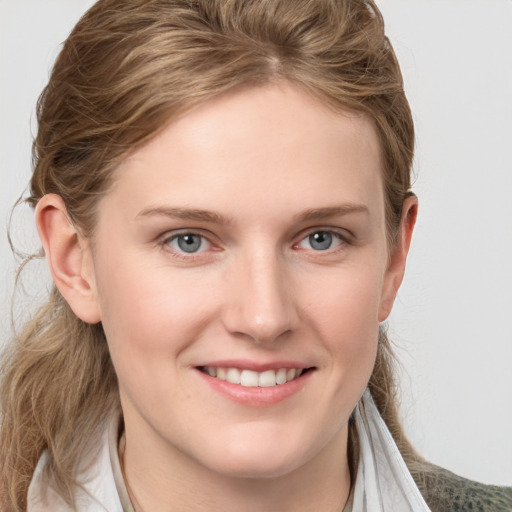 Joyful white young-adult female with medium  brown hair and blue eyes