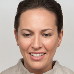 Joyful white adult female with short  brown hair and brown eyes
