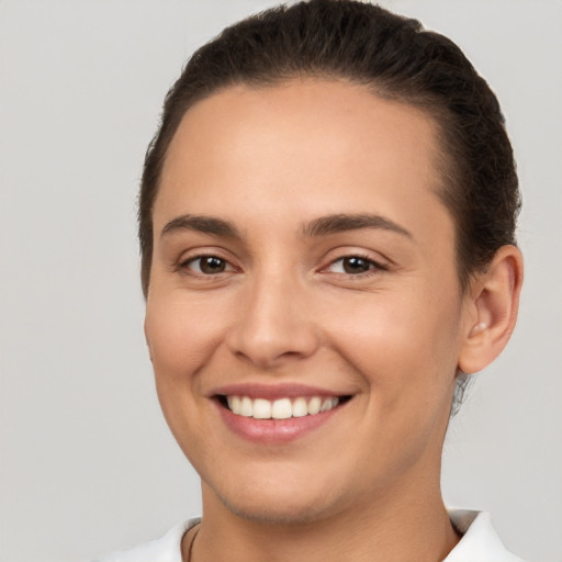 Joyful white young-adult female with short  brown hair and brown eyes