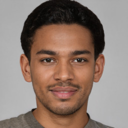 Joyful latino young-adult male with short  brown hair and brown eyes