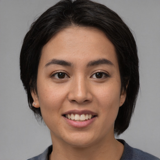 Joyful latino young-adult female with medium  black hair and brown eyes