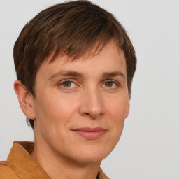 Joyful white adult male with short  brown hair and grey eyes