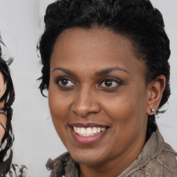 Joyful black young-adult female with medium  brown hair and brown eyes