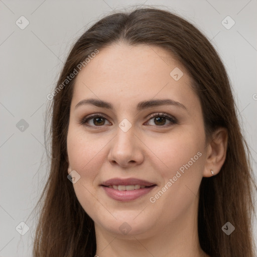 Joyful white young-adult female with long  brown hair and brown eyes