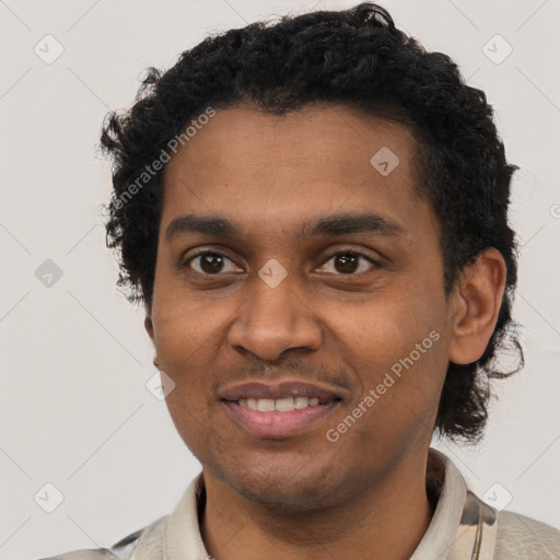 Joyful black young-adult male with short  black hair and brown eyes