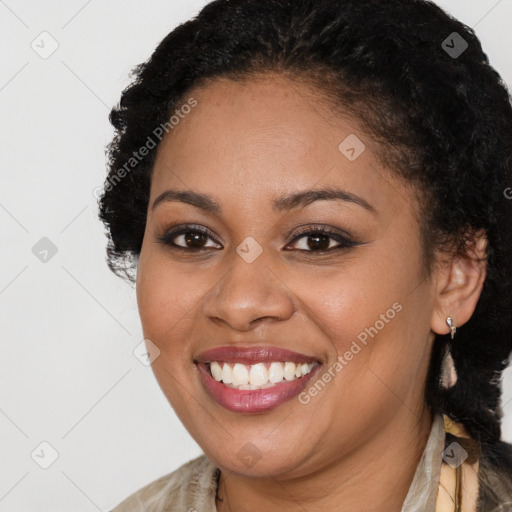 Joyful black young-adult female with long  brown hair and brown eyes