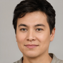 Joyful asian young-adult male with short  brown hair and brown eyes