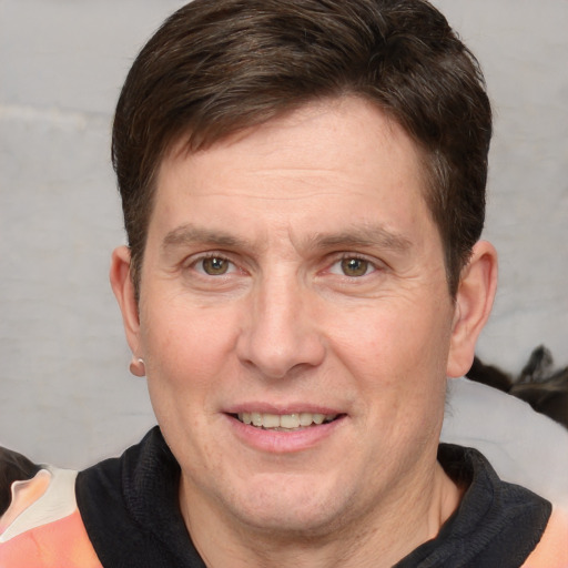 Joyful white adult male with short  brown hair and grey eyes