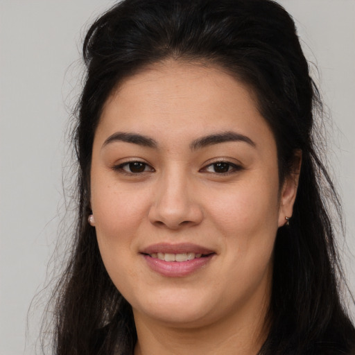 Joyful latino young-adult female with long  brown hair and brown eyes