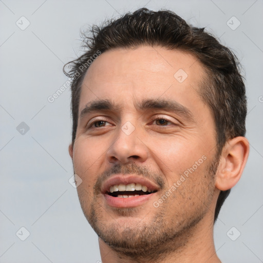 Joyful white adult male with short  brown hair and brown eyes