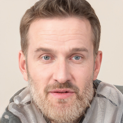 Joyful white adult male with short  brown hair and grey eyes