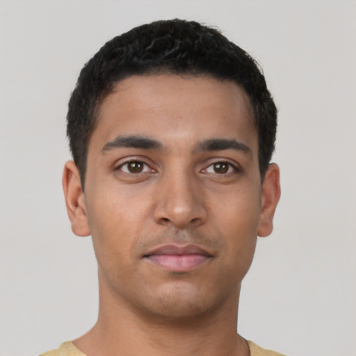 Joyful latino young-adult male with short  brown hair and brown eyes