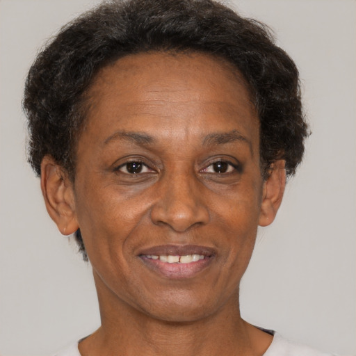 Joyful black adult female with short  brown hair and brown eyes