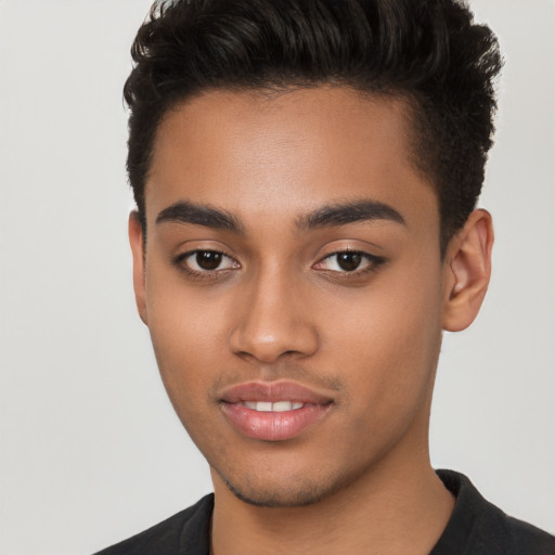 Joyful latino young-adult male with short  brown hair and brown eyes