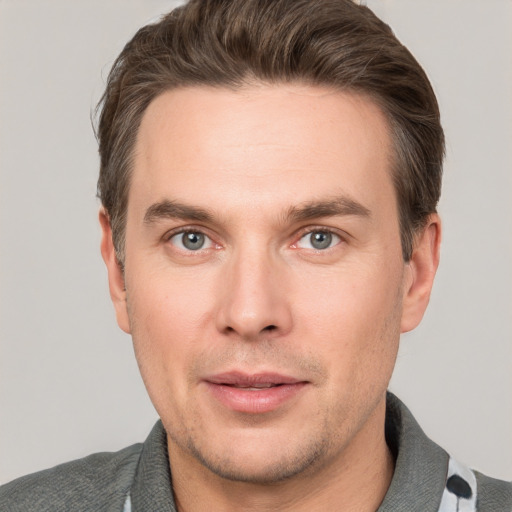 Joyful white adult male with short  brown hair and grey eyes