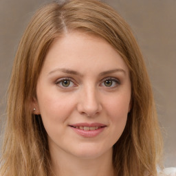 Joyful white young-adult female with long  brown hair and green eyes