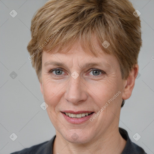 Joyful white adult female with short  brown hair and grey eyes