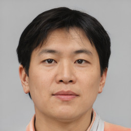 Neutral asian adult male with short  brown hair and brown eyes