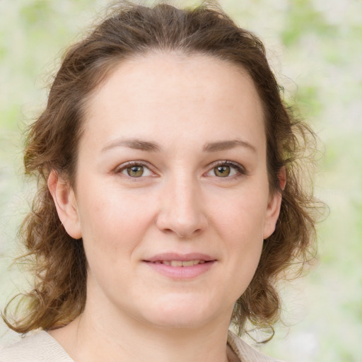 Joyful white young-adult female with medium  brown hair and green eyes