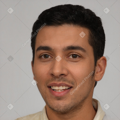 Joyful white young-adult male with short  black hair and brown eyes