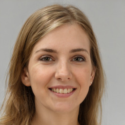 Joyful white young-adult female with long  brown hair and green eyes