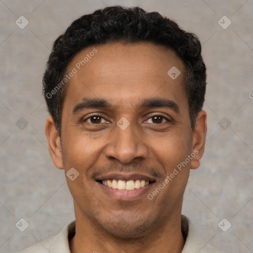 Joyful latino young-adult male with short  black hair and brown eyes