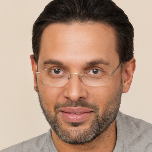 Joyful white adult male with short  brown hair and brown eyes