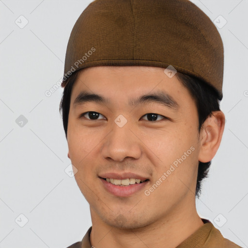 Joyful asian young-adult male with short  brown hair and brown eyes