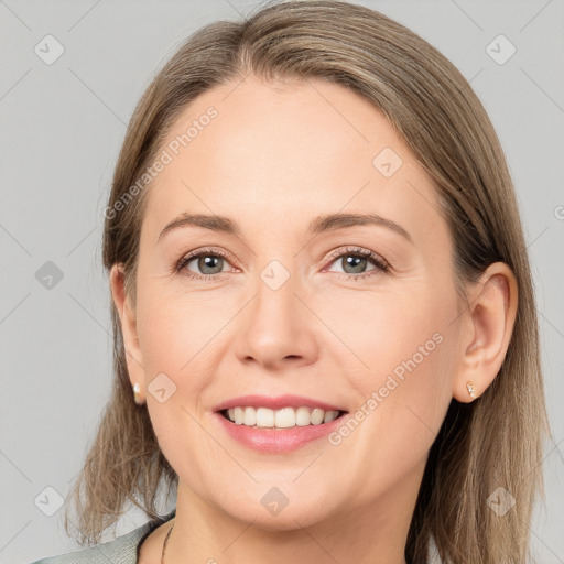 Joyful white adult female with medium  brown hair and grey eyes