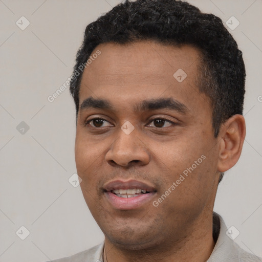 Joyful latino young-adult male with short  black hair and brown eyes