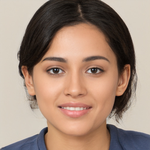 Joyful white young-adult female with medium  black hair and brown eyes