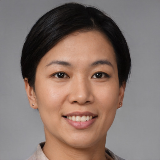 Joyful asian young-adult female with short  brown hair and brown eyes