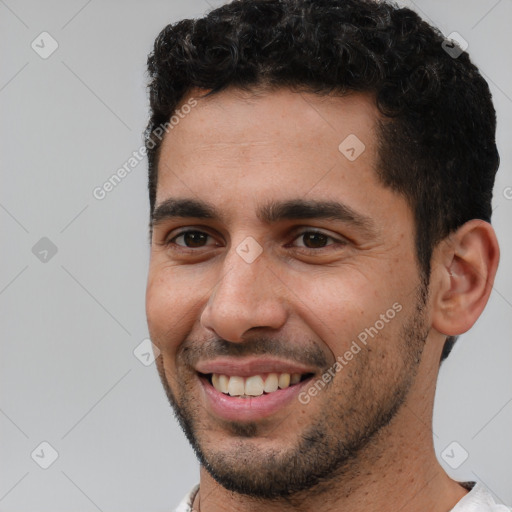 Joyful white young-adult male with short  black hair and brown eyes