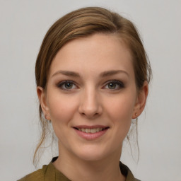 Joyful white young-adult female with medium  brown hair and grey eyes