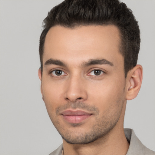 Joyful white young-adult male with short  brown hair and brown eyes