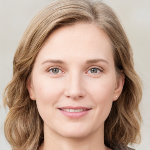 Joyful white young-adult female with medium  brown hair and blue eyes