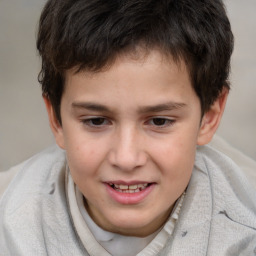 Joyful white child male with short  brown hair and brown eyes