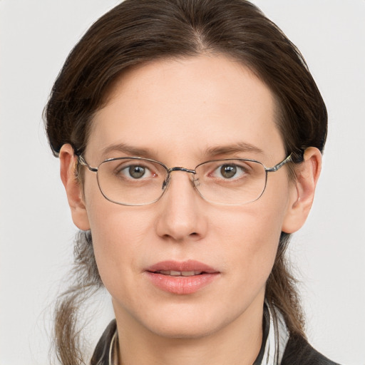 Joyful white adult female with medium  brown hair and grey eyes