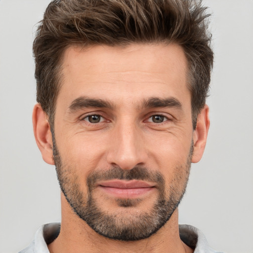 Joyful white adult male with short  brown hair and brown eyes