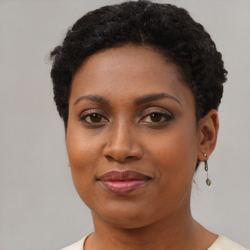 Joyful black young-adult female with short  brown hair and brown eyes
