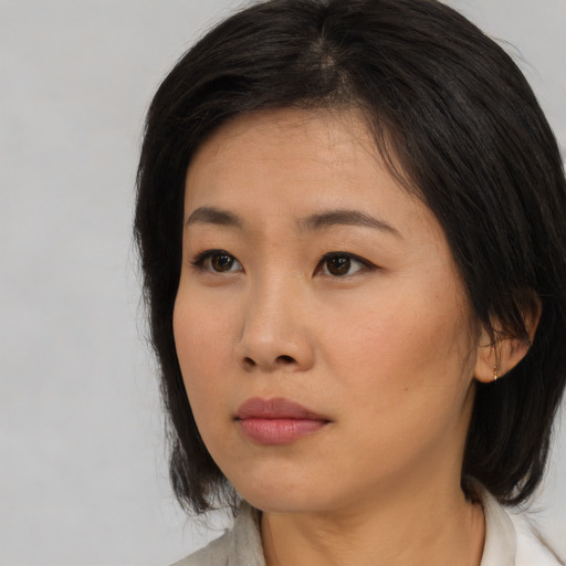 Neutral asian young-adult female with medium  brown hair and brown eyes