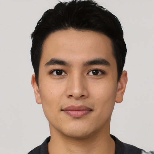 Joyful asian young-adult male with short  black hair and brown eyes