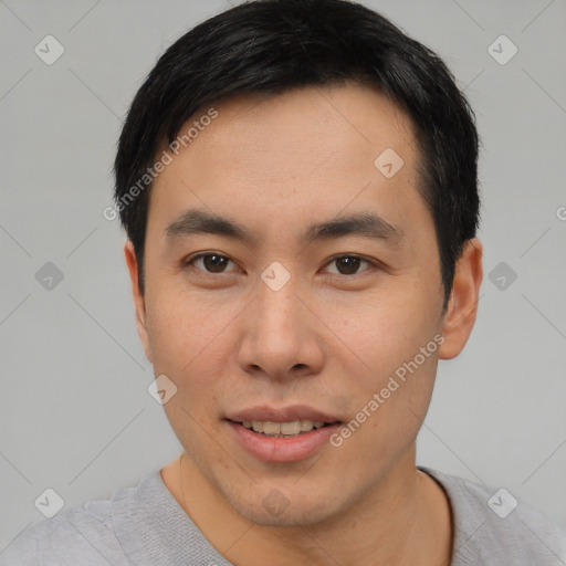 Joyful asian young-adult male with short  black hair and brown eyes