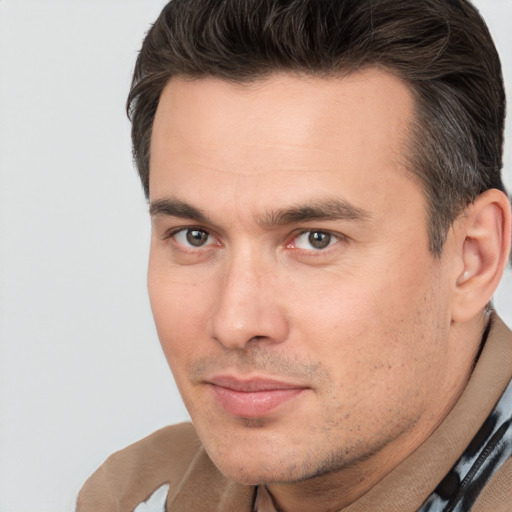 Joyful white adult male with short  brown hair and brown eyes