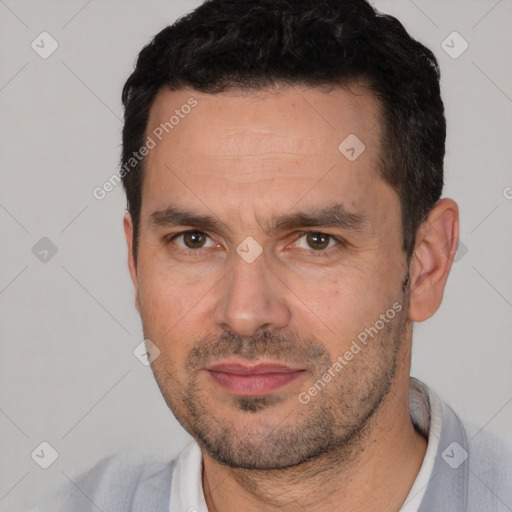 Joyful white adult male with short  black hair and brown eyes