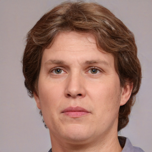 Joyful white adult male with medium  brown hair and green eyes