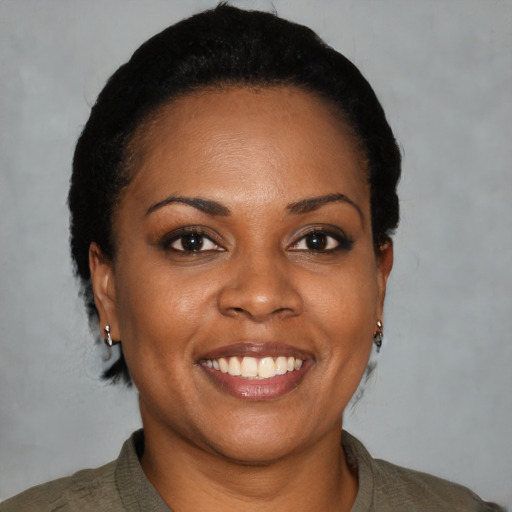 Joyful black young-adult female with short  black hair and brown eyes
