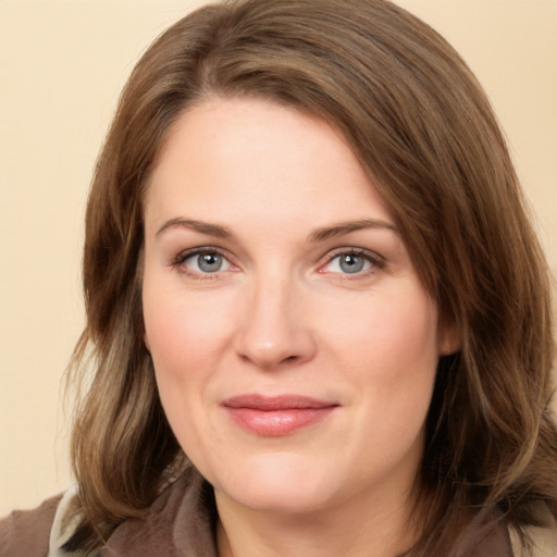 Joyful white young-adult female with long  brown hair and grey eyes