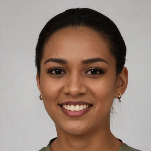 Joyful latino young-adult female with short  black hair and brown eyes