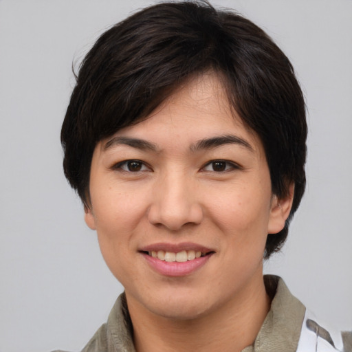 Joyful asian young-adult female with medium  brown hair and brown eyes